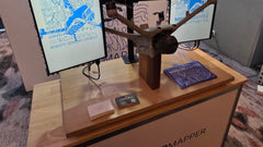 Finished Mirrormapper booth at RPAS in Australian Skies 2026: map wall, two screens and a drone on a timber stand