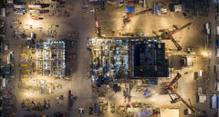 Night overhead of an active construction pad. The measured site a drone model can overlay on the design BIM