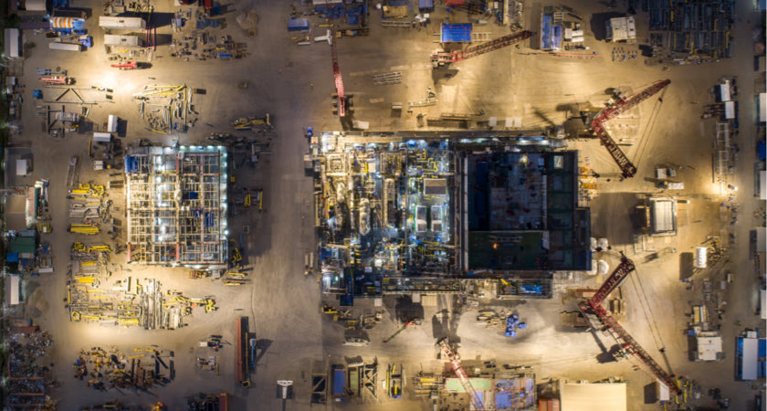 Night overhead of an active construction pad. The measured site a drone model can overlay on the design BIM