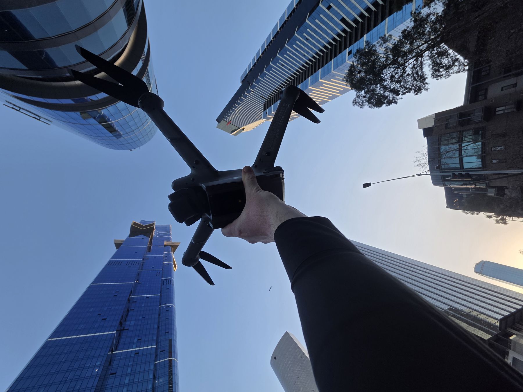 Drone held up between city towers