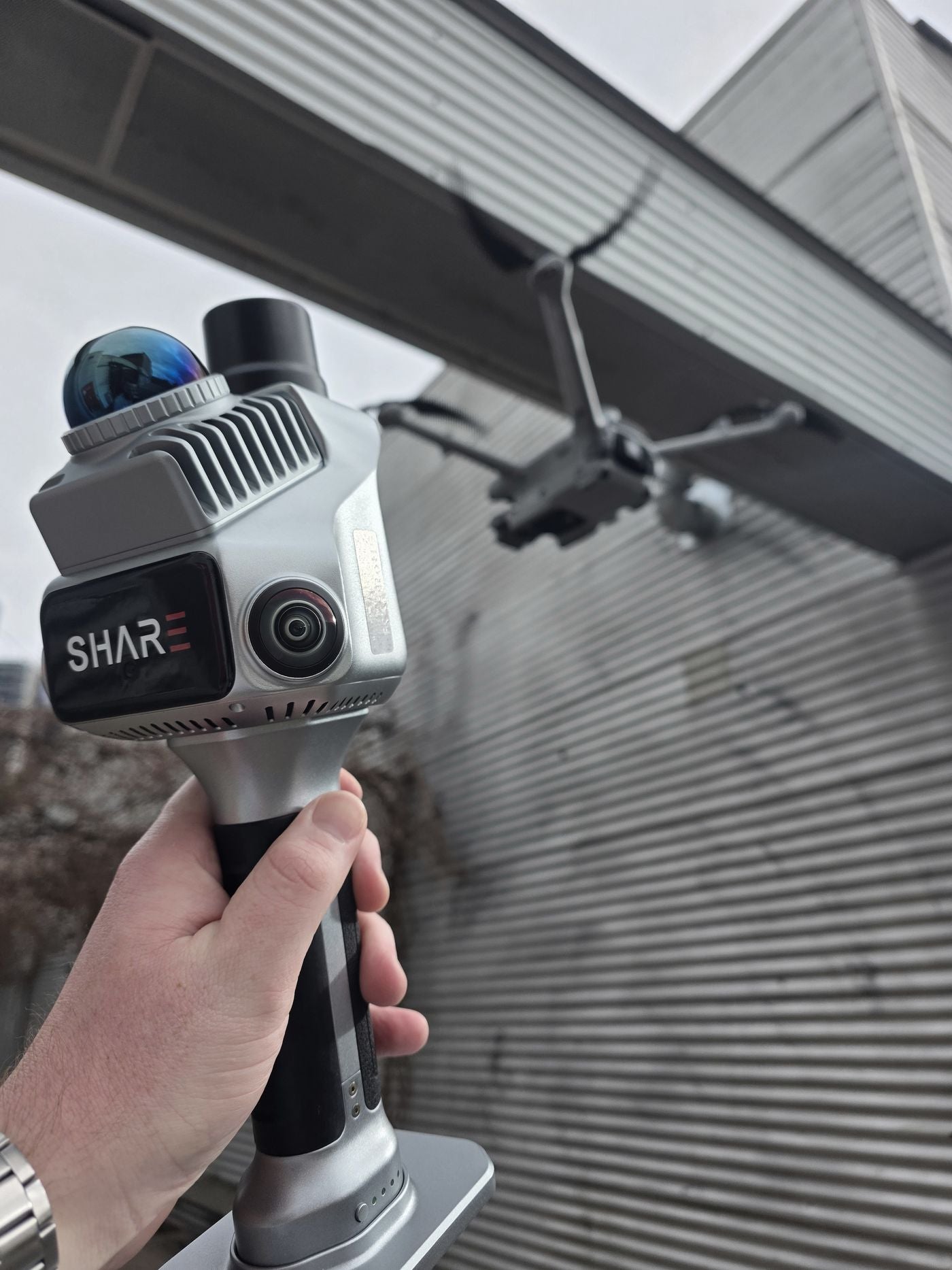 Handheld scanner and drone on site
